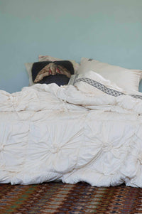 Rosette Natural La Belle Sheets Moth Cushion on bed