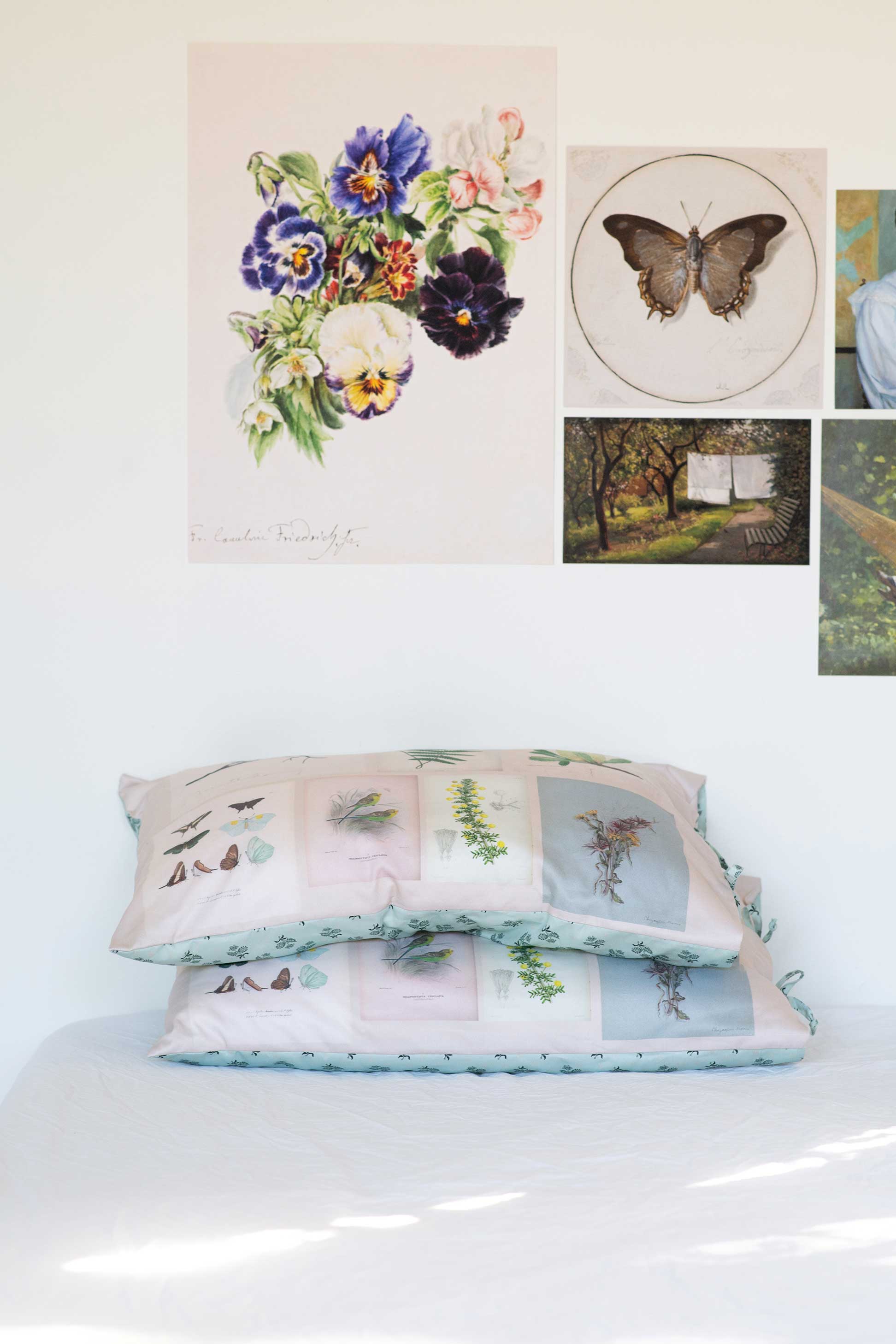 Scrapbook Pillowcase Set with floral & butterfly art prints on a wall.