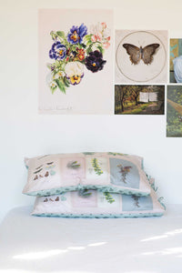 Scrapbook Pillowcase Set with floral & butterfly art prints on a wall.