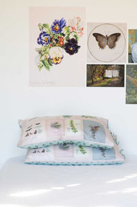 Scrapbook Pillowcase Set with floral & butterfly art prints on a wall.