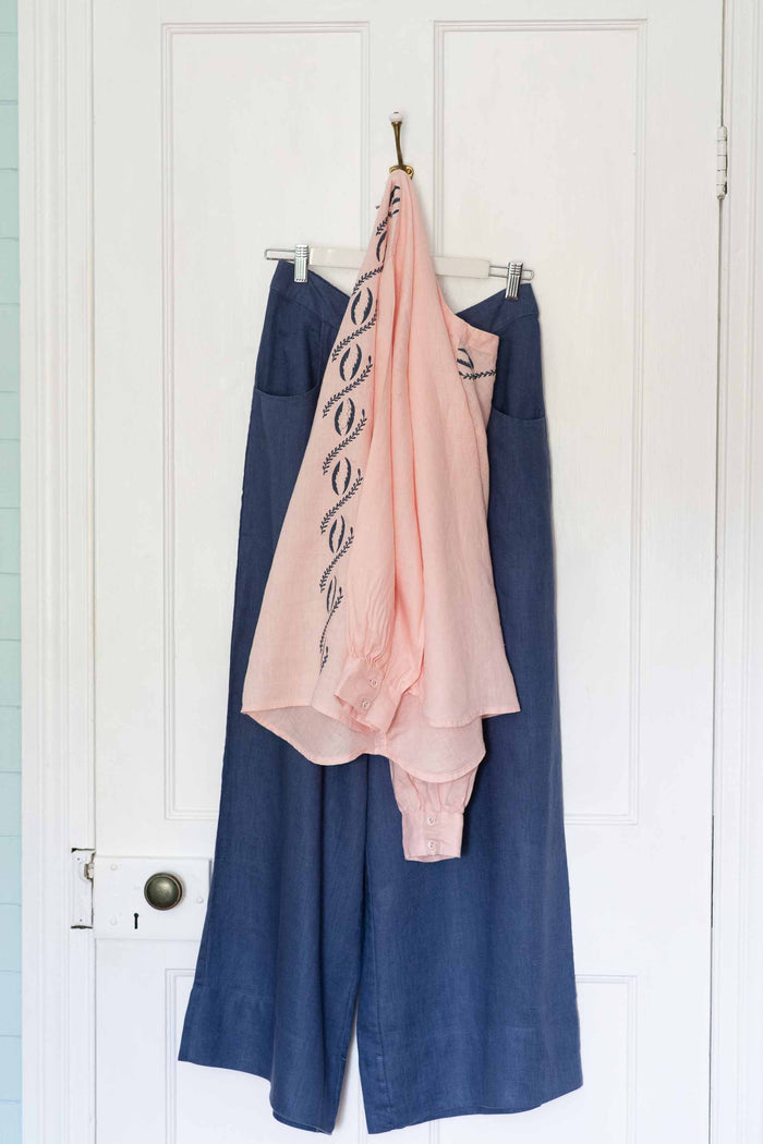 Simona Top & Ollie Indigo pants hanging on a door.