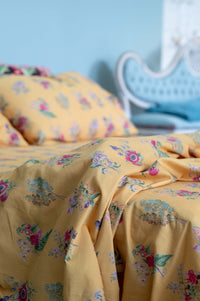 Yellow floral bedsheets on display.