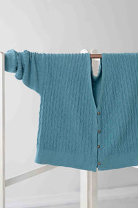 Sunday Cardigan Marine blue cable knit sweater hanging