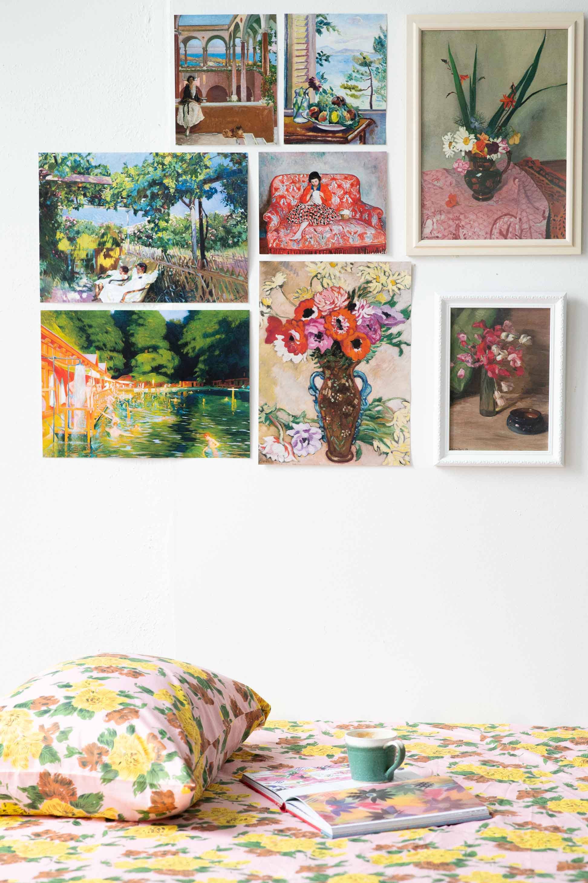 Gallery wall with colorful art and floral bedding