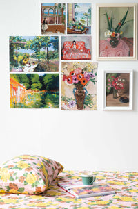 Gallery wall with colorful art and floral bedding