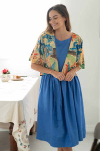 Wren Gentian Jane Lapis Dress, woman in blue dress and printed jacket.