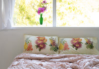 Floral pillows and azalea flowers by window.