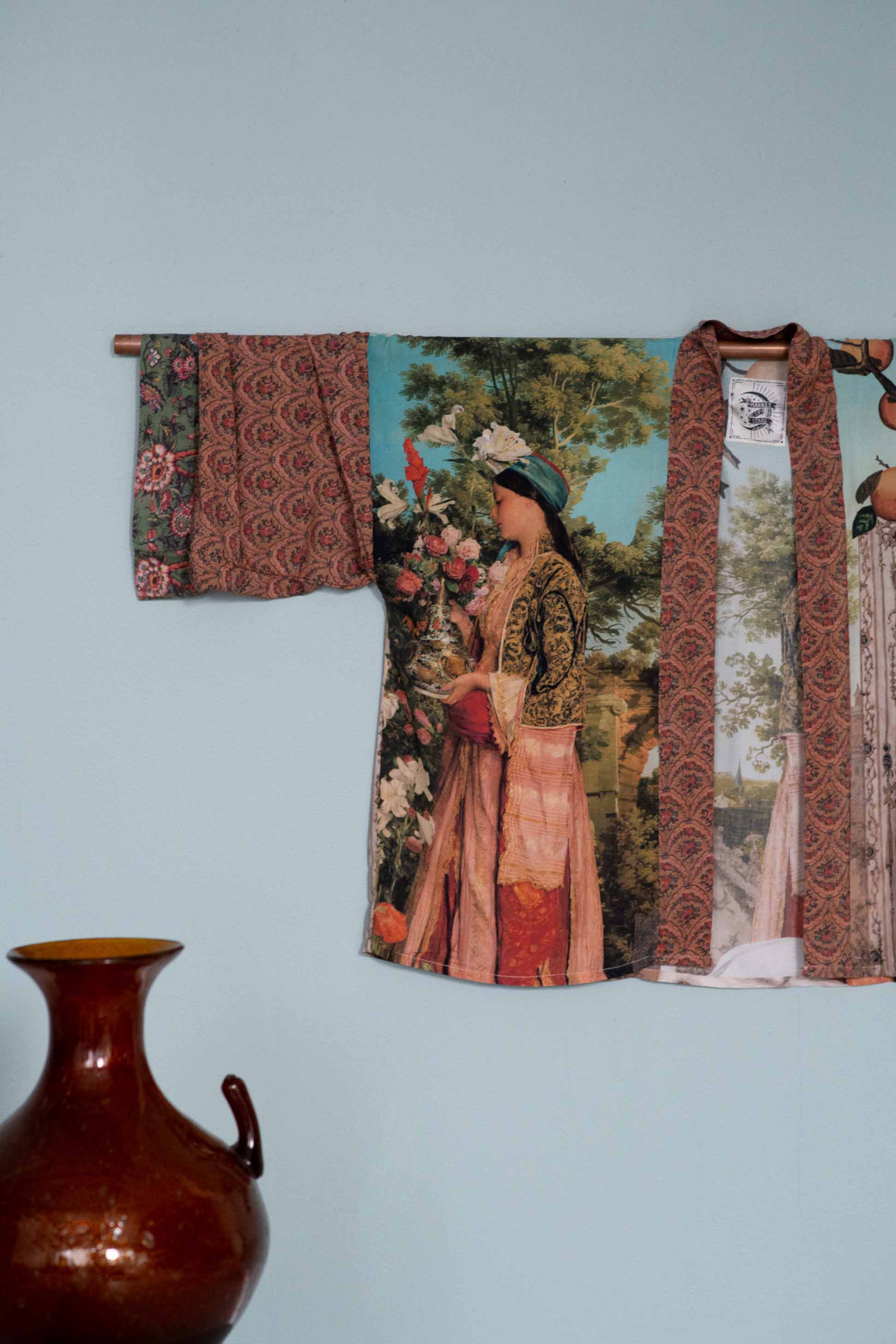 Kimono wall hanging with woman in floral scene.