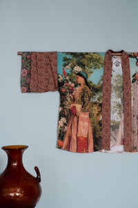Kimono wall hanging with woman in floral scene.