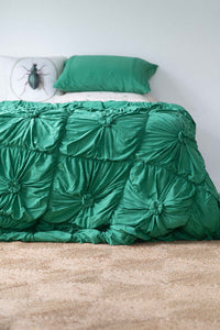 Green rosette bedspread with golden beetle pillow