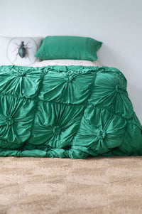 Green rosette bedspread with golden beetle pillow
