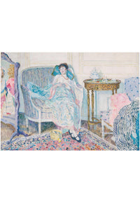 Woman in a chair, with mirror, table, and patterned rug.