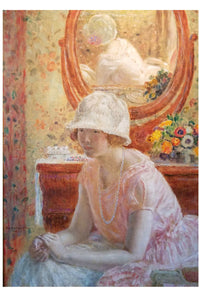 Woman in a pink dress and hat sitting in front of a mirror.