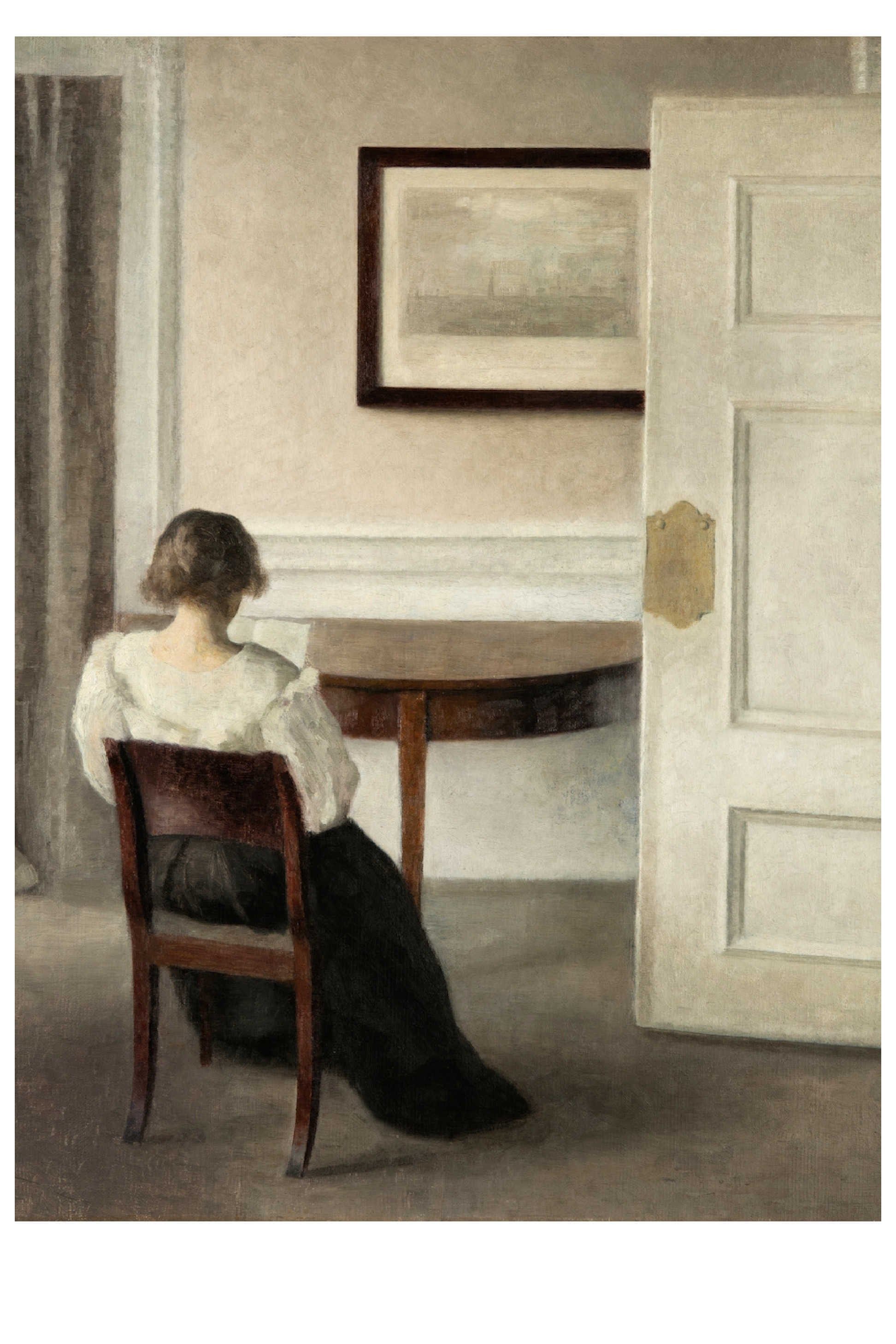 Woman seated in a room, facing away, with a table and open door.