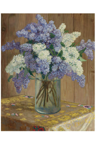 Bouquet of purple and white lilacs in a glass vase.