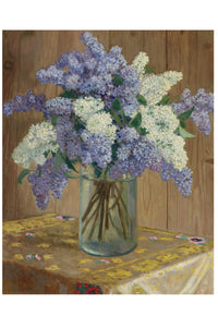 Bouquet of purple and white lilacs in a glass vase.
