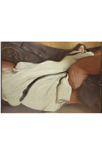 Woman in white dress reclining on a sofa.