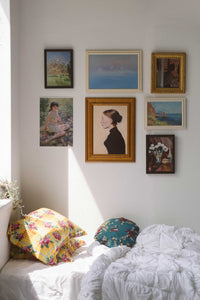 Art prints and Crisanta round cushion set on white bed