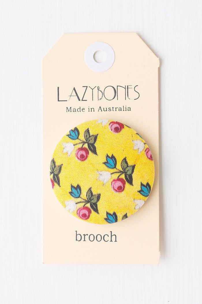 Brooch_Mellow floral pattern on yellow fabric.
