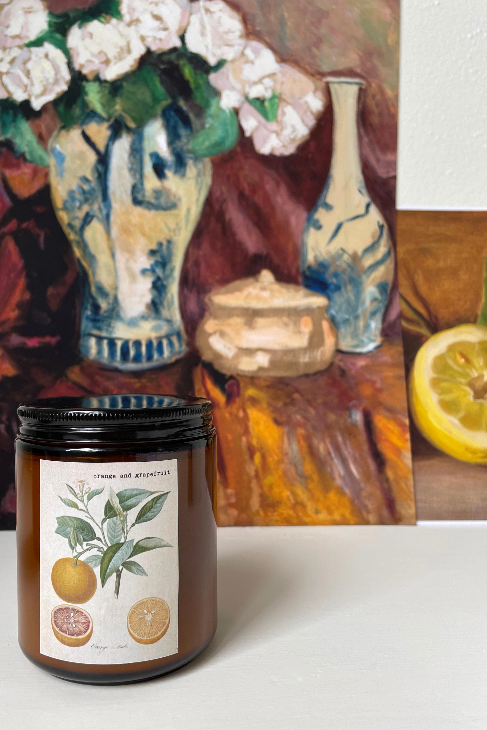 Orange grapefruit candle with still life background