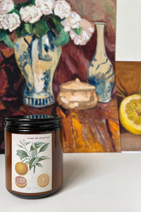 Orange grapefruit candle with still life background
