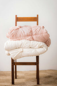 Quilt Rosette, Tuscan Pink and Natural, stacked on chair