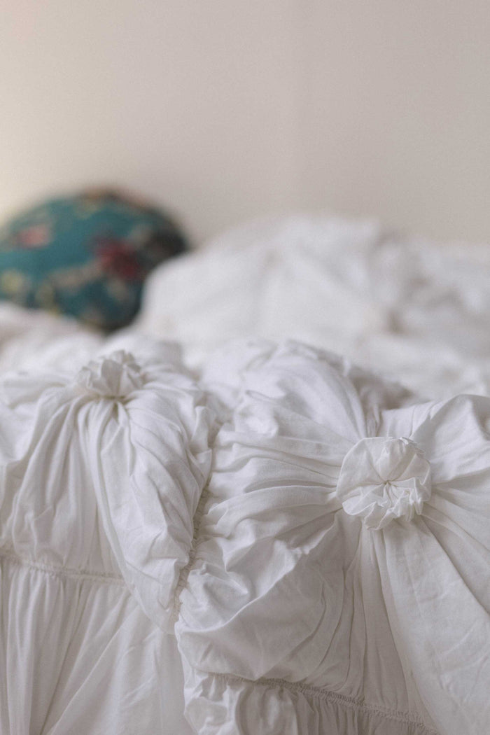 White rosette quilt on bed