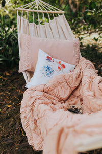 Tuscan pink quilt, pillowcase set, and cushion cover in a hammock