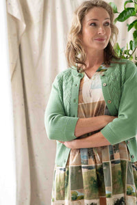 Woman in green cardigan & dress