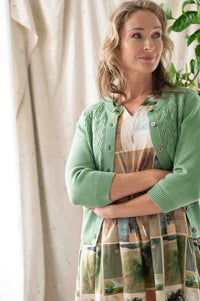 Woman in green cardigan & dress