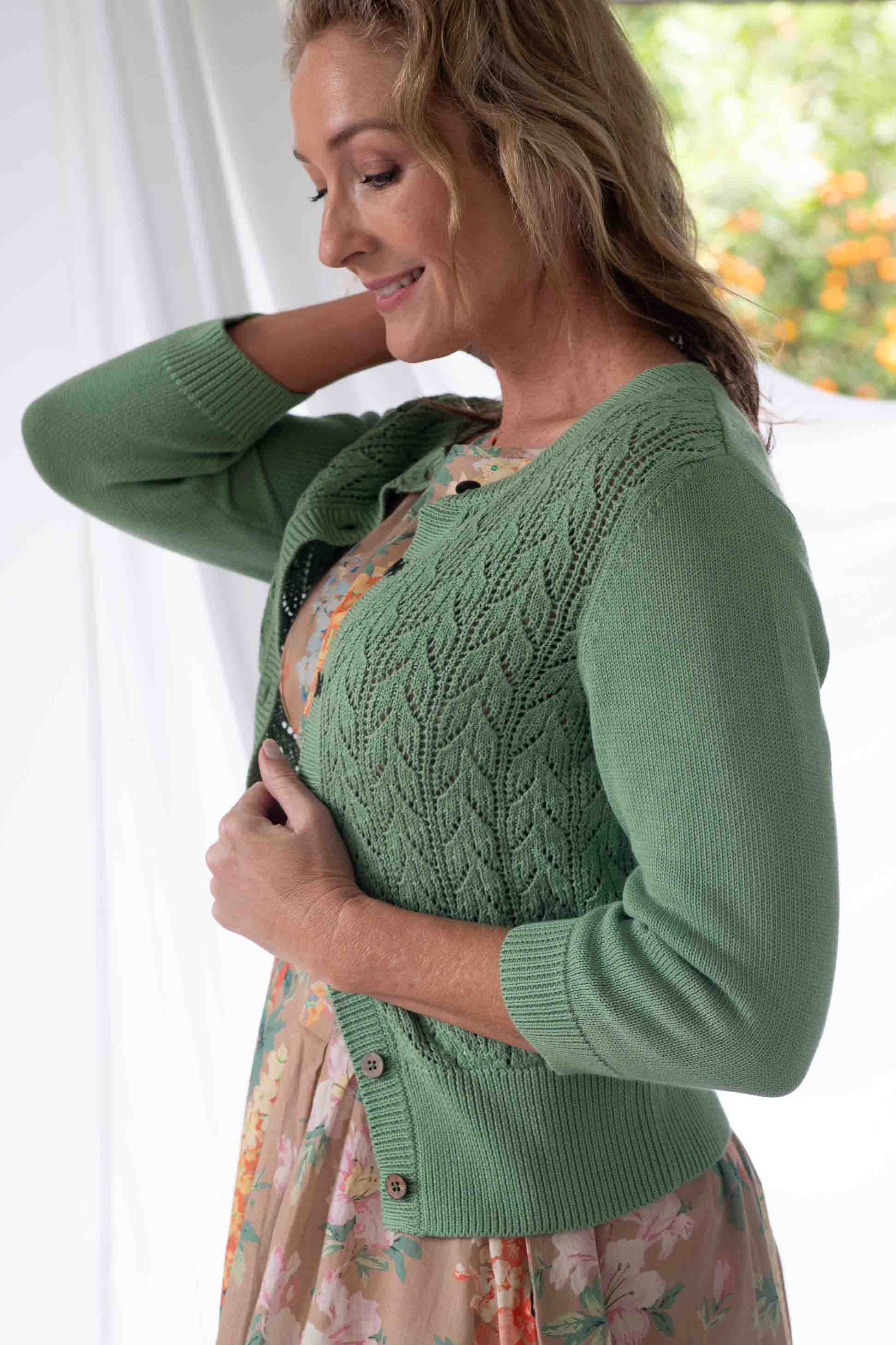 Woman in green cardigan, Ava Mineral Jasmine Flora