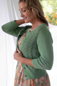 Woman in green cardigan, Ava Mineral Jasmine Flora