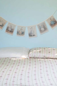 Ballerina garland above bed with Idony sheets