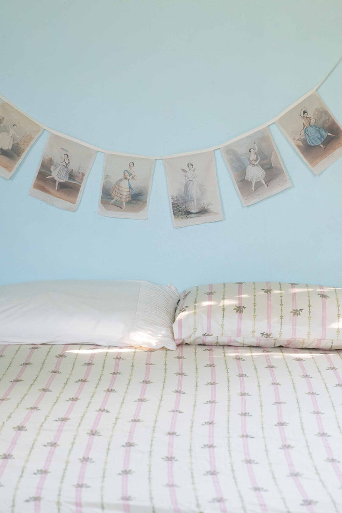 Ballerina garland above bed with Idony sheets