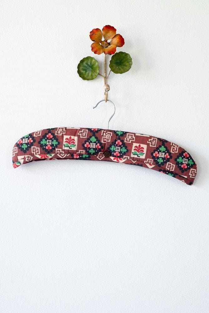 Clover-shaped padded hanger with floral design and wall decor