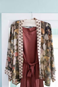 Floral kimono & rust-colored dress hanging on door