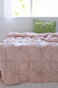 Pink tufted comforter on bed, DSC2443
