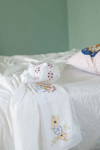 Embroidered linens on bed, DSC4622