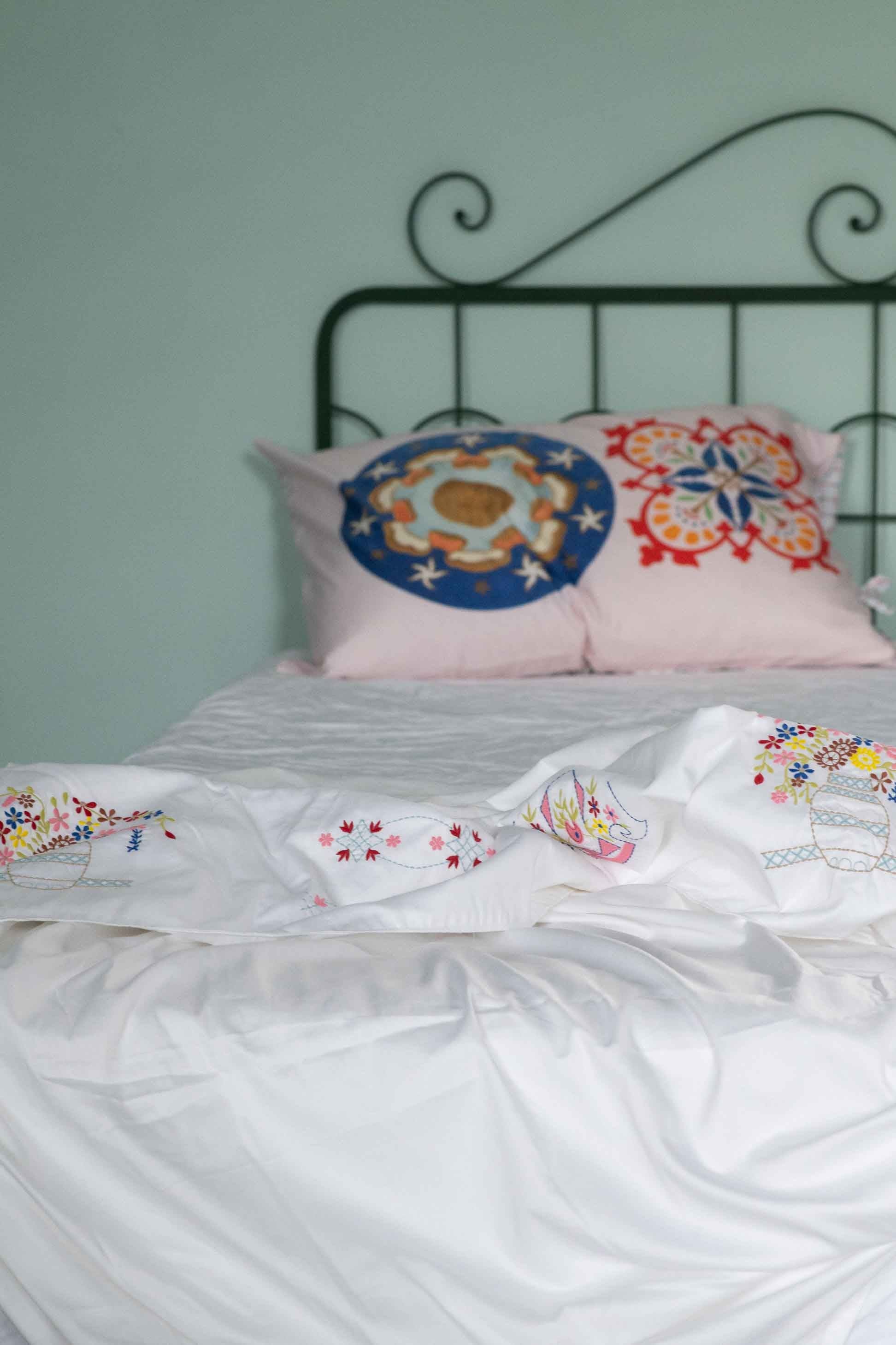Bedroom with embroidered pillows and bedding - DSC4656