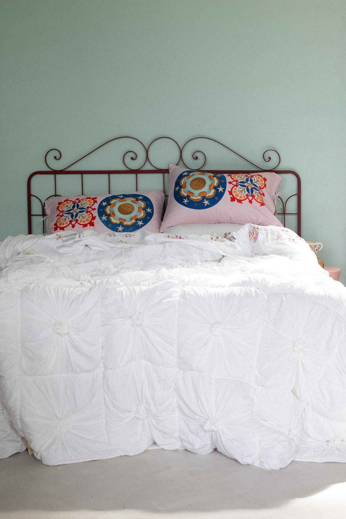 Bed with white comforter and decorative pillows - DSC4895