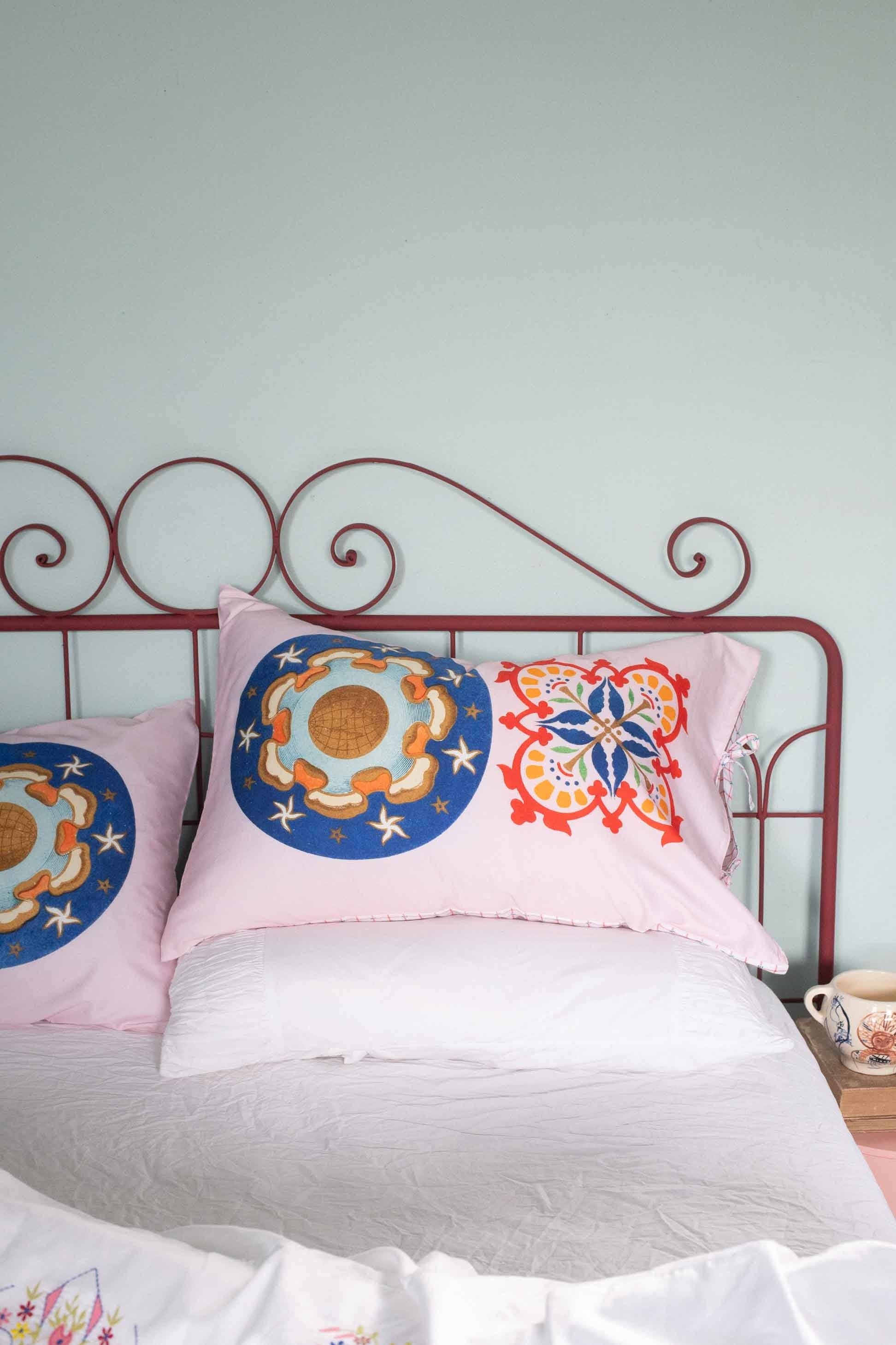 Pink patterned pillows on bed - DSC4946