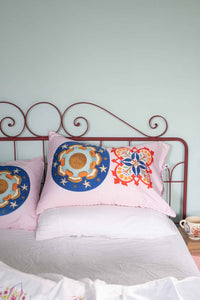 Pink patterned pillows on bed - DSC4946