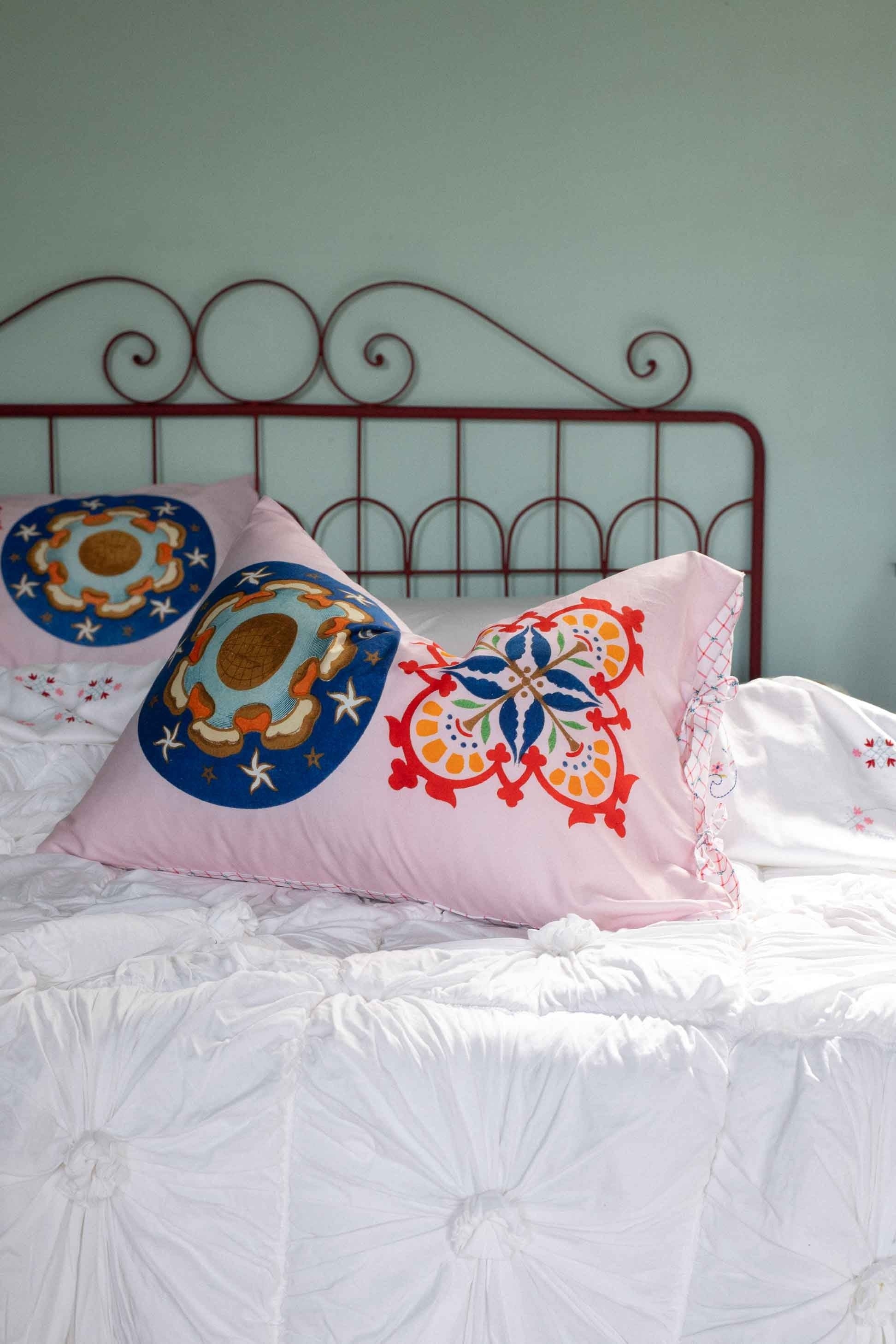 Pink decorative pillows on white bed, DSC4977