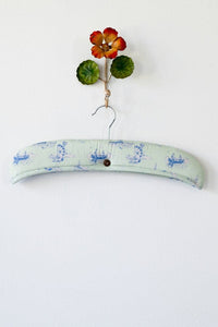 Decorative padded hanger with floral accent