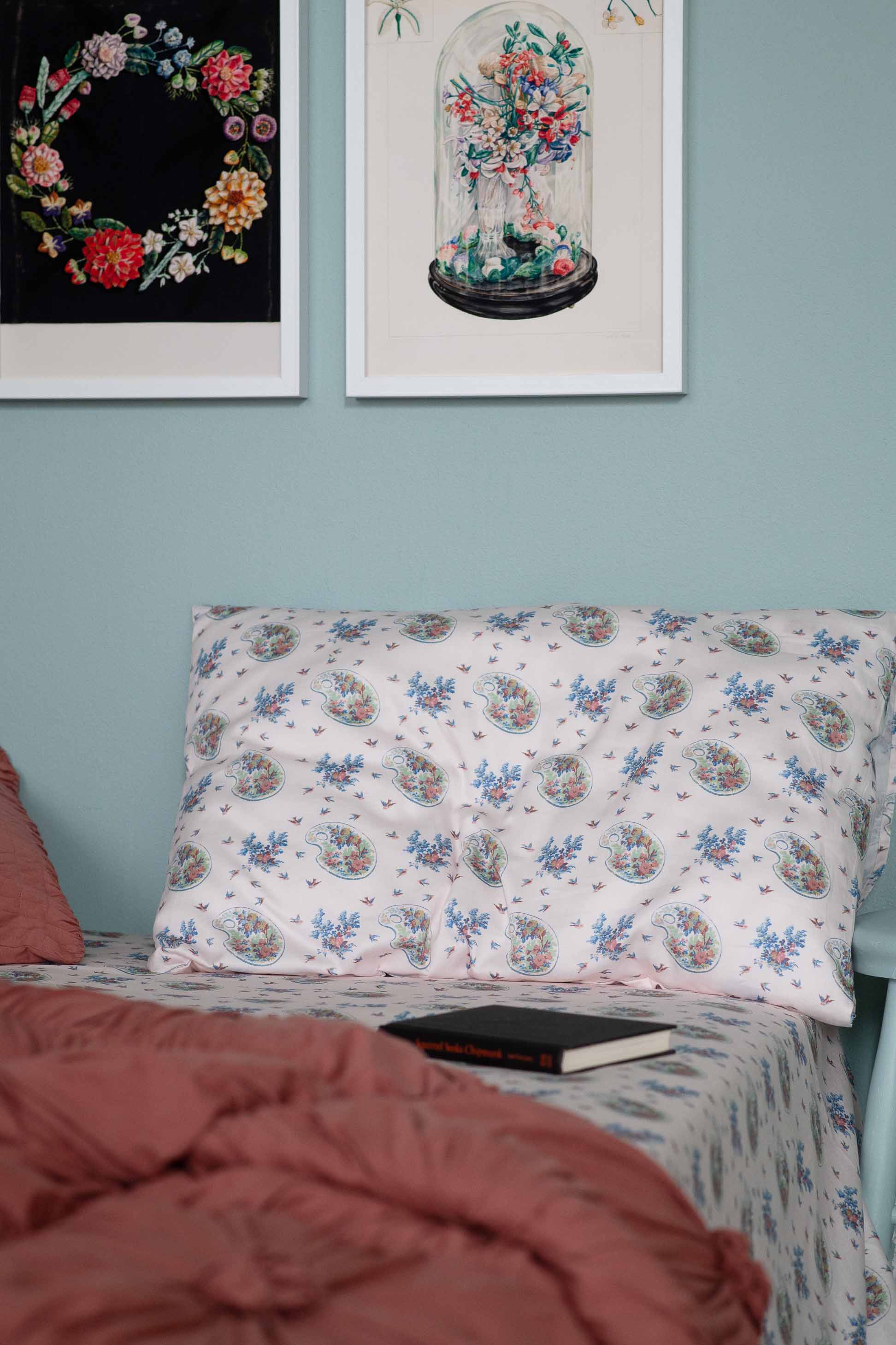 Bedroom decor featuring floral artwork and patterned bedding, DSC9656