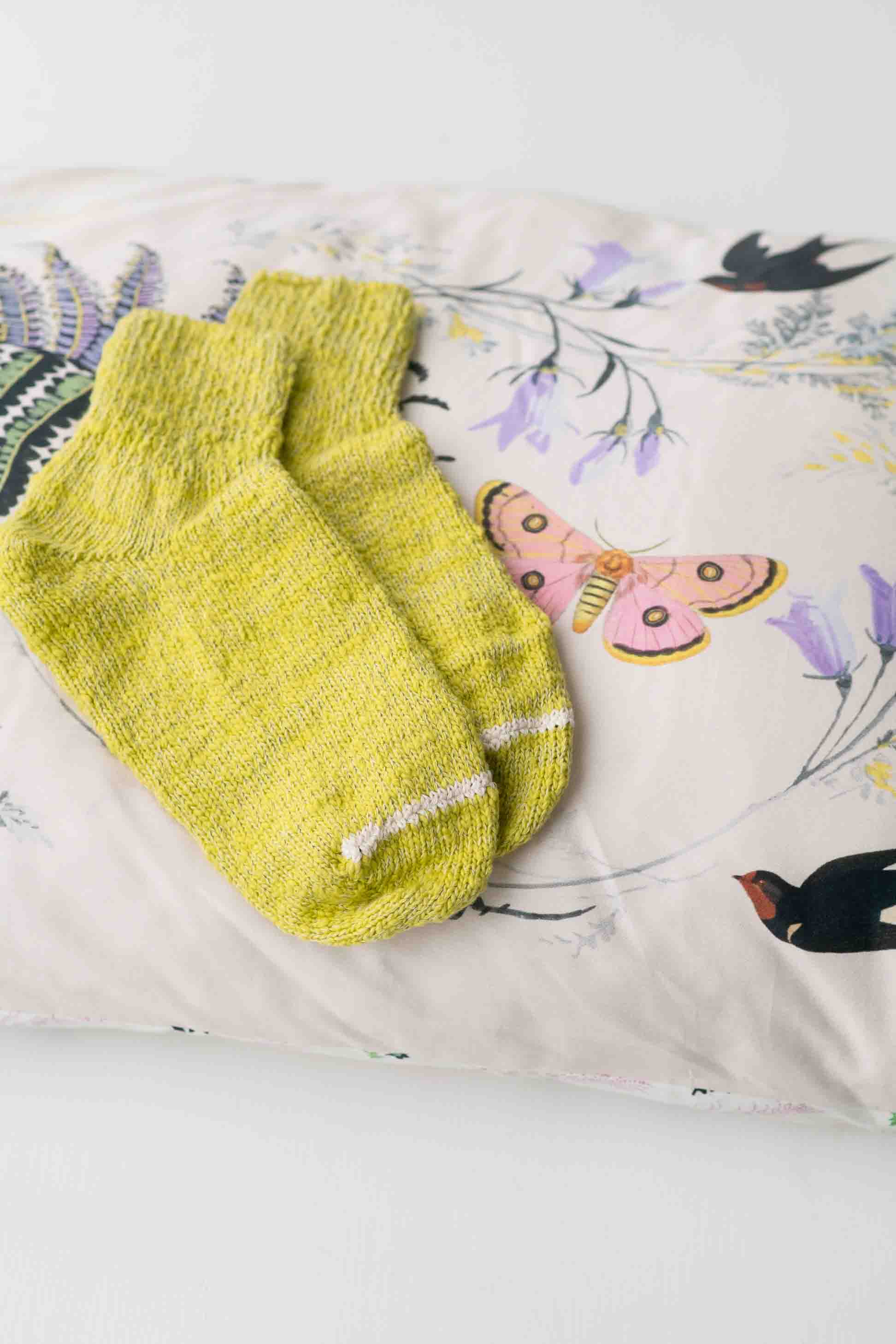 Garabou Chartreuse socks on floral pillow