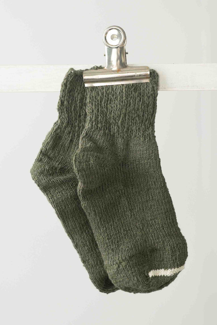 Garabou Khaki socks clipped to a line