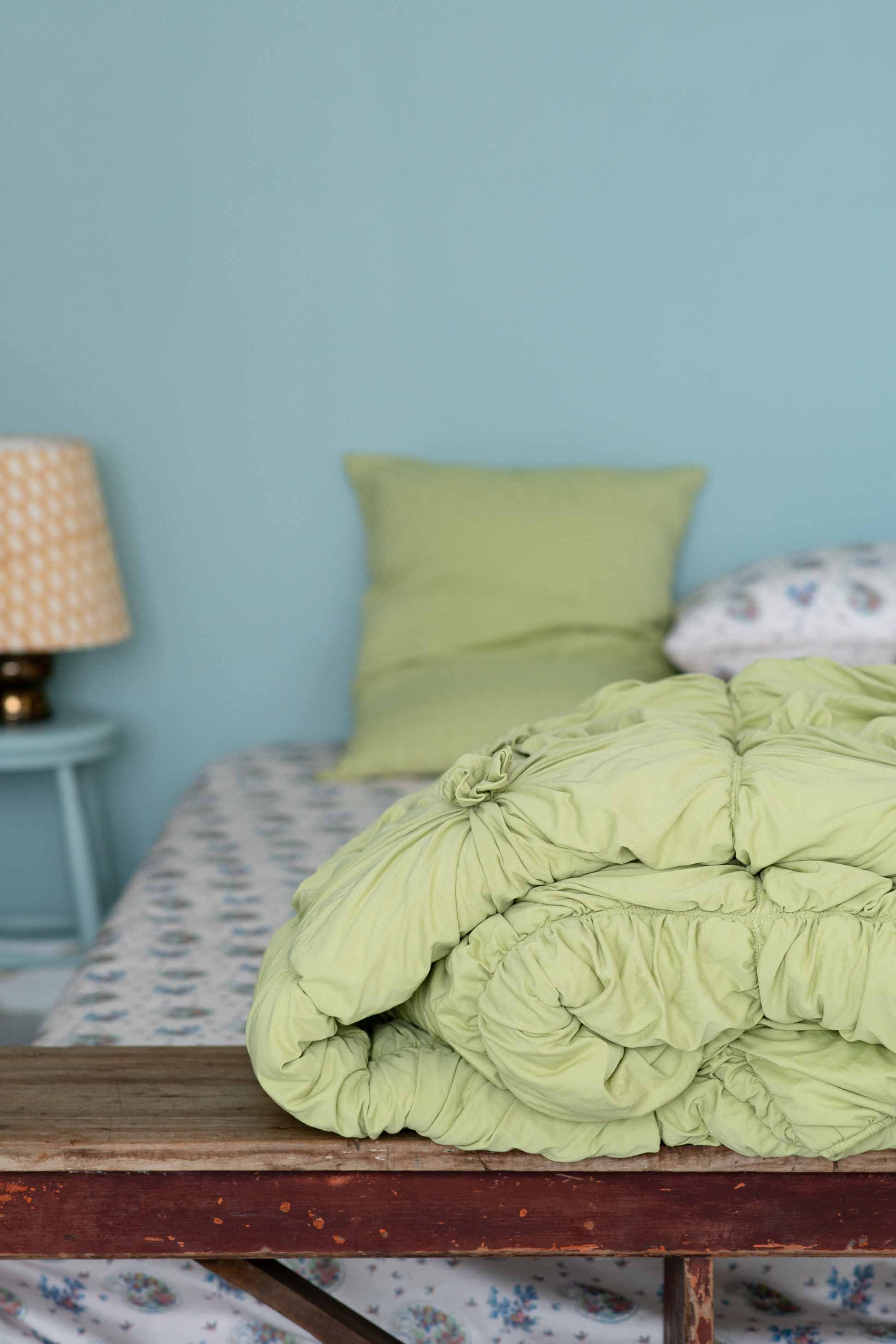 Green tea rosette bedding on a bed