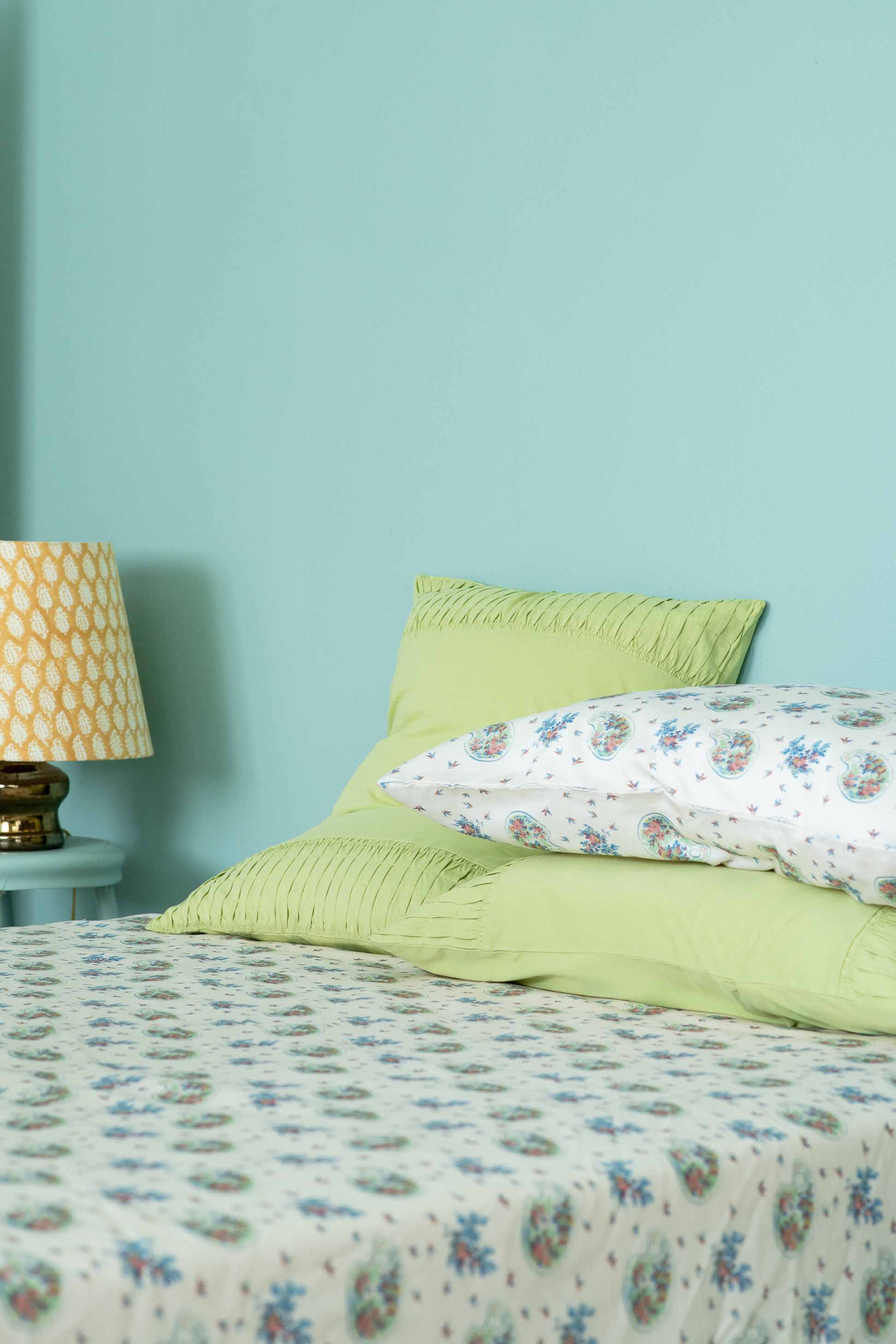 Green tea rosette sheets on bed with pillows