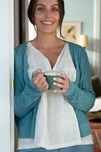 Julia White Sunday Cardigan Marine holding mug